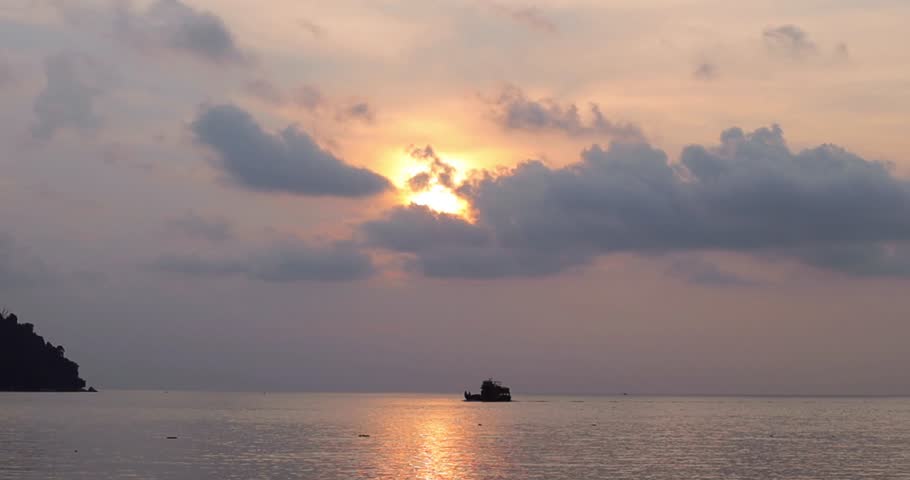 Boat in the sea at sunset with cloudy sky, Malaysia