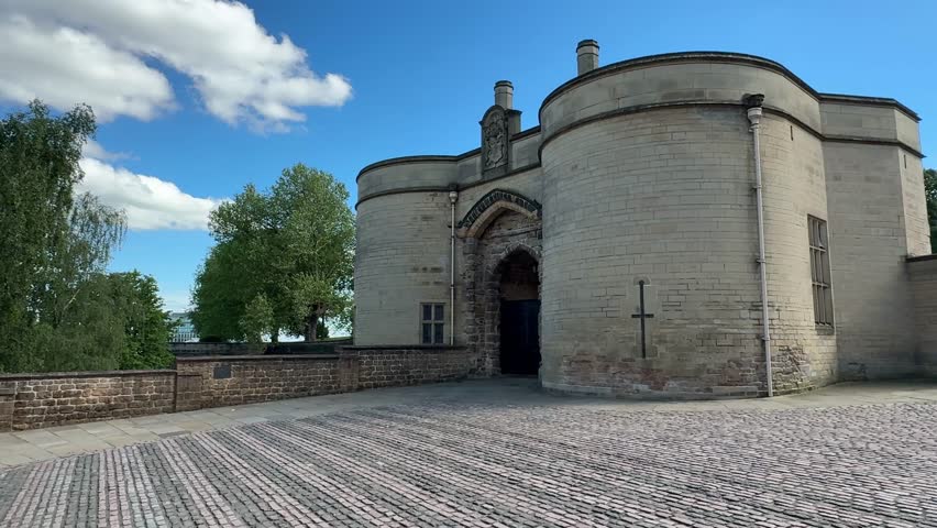Entrance view of Nottingham Castle near Old Market Square and Robin Hood statue in Nottingham, East Midlands, England, showcasing historic architecture.