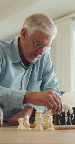Old man, chess and game in home with strategy, solution or problem solving in contest in living room. Senior person, boardgame and idea with competition for thinking, knowledge or challenge on sofa