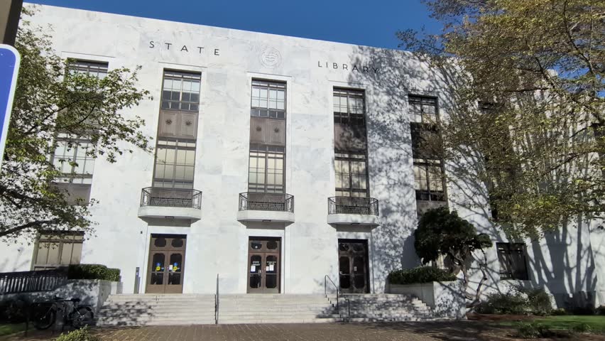 Video of the Oregon State Library showcasing marble architecture, engraved state seal, landscaped grounds and grand entrance on a bright spring day in Salem.