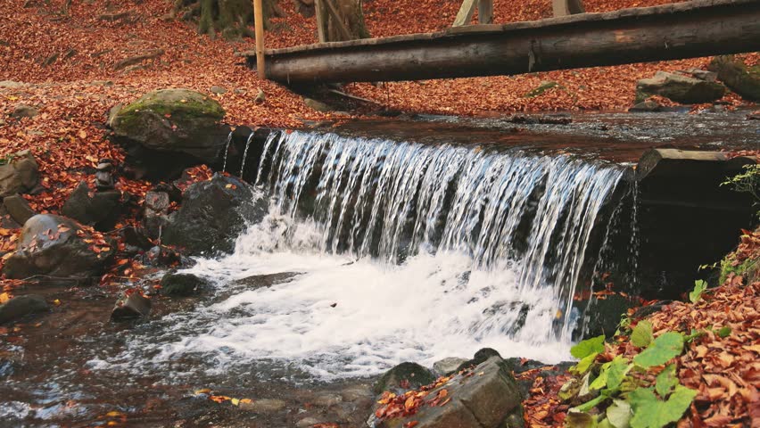 Large boulders overgrown with moss at waterfall