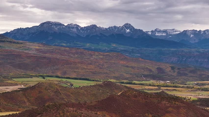 Panoramic aerial view of Colorado fall landscapes featuring mountain peaks and fall foliage while capturing the beauty of Dallas Divide in the San Juan Mountain national forest wilderness - 4K Drone