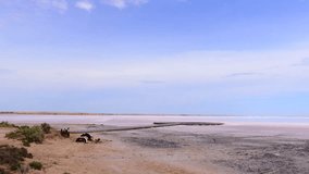 Aerial drone shot over the dry Chott el Djerid salt lake. Cinematic perspective of the vast crystalline salt flats under a cloudy sky in southern Tunisia, North Africa. - Powered by Shutterstock - Get 15% off with code: PIKWIZARD15