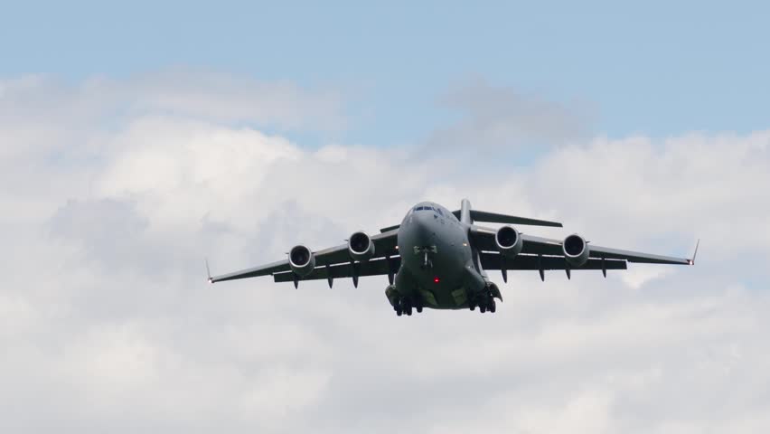 C-17 Globemaster performs takeoff for strategic airlift operation. Aircraft is involved in troop transport and heavy cargo delivery missions.