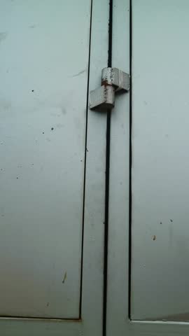 Close-up of a weathered metal surface with a torn section