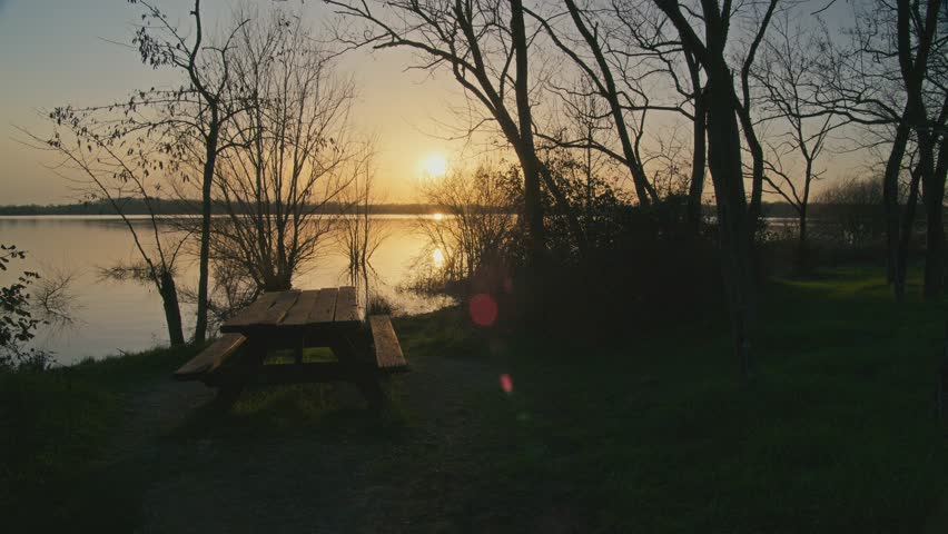 Peaceful lake in nature during golden hour with warm sunlight