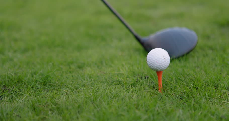 Hands, golf ball and exercise or tee, sports and competition on grass, challenge and tournament. Person, relax and closeup for game, practice and hobby or recreation, action and equipment for match