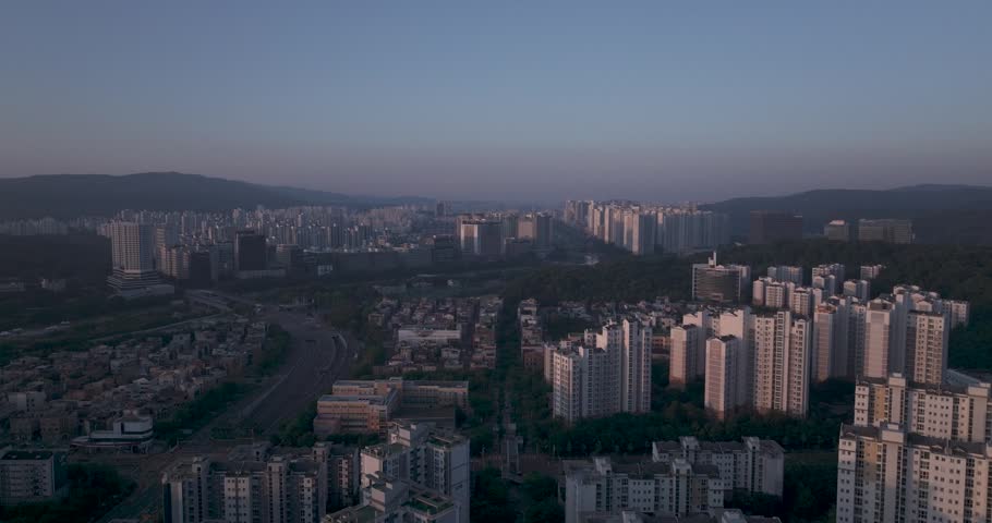 Aerial view of the unique futuristic skybridge and modern glass architecture skyscrapers surrounding Pangyo Station area in the morning light, Seongnam, South Korea.