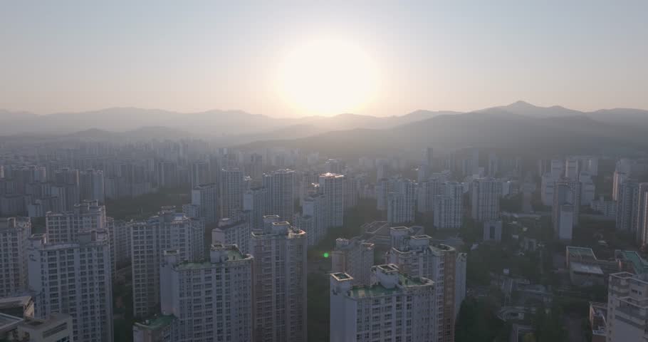 Aerial view of the unique futuristic skybridge and modern glass architecture skyscrapers surrounding Pangyo Station area in the morning light, Seongnam, South Korea.