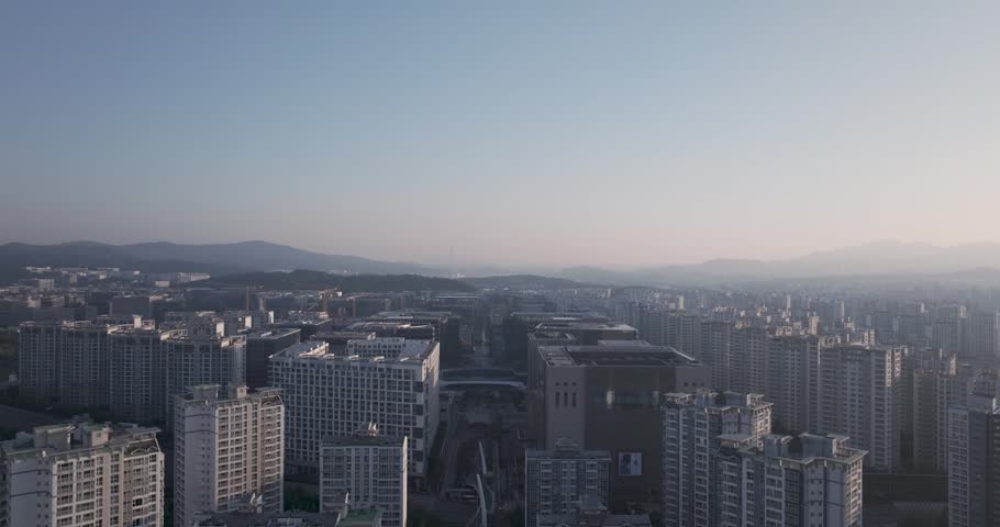 Aerial view of the unique futuristic skybridge and modern glass architecture skyscrapers surrounding Pangyo Station area in the morning light, Seongnam, South Korea.