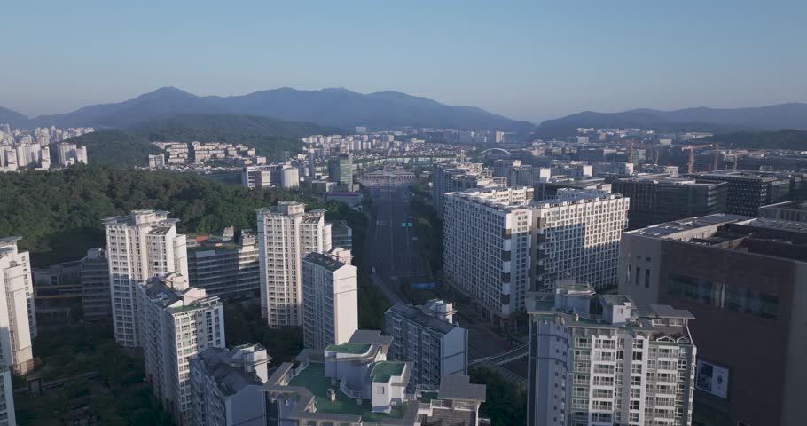 Aerial view of the unique futuristic skybridge and modern glass architecture skyscrapers surrounding Pangyo Station area in the morning light, Seongnam, South Korea.