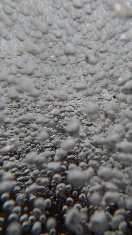 Rapid, chaotic movement of air bubbles in fast underwater current, natural background. Moves inside turbulent, wild dance of oxygen look like liquid diamonds, spinning in disorderly high-energy vortex
