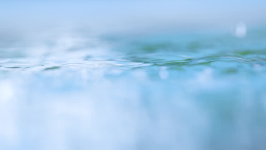 Close-up of raindrops falling on the water surface