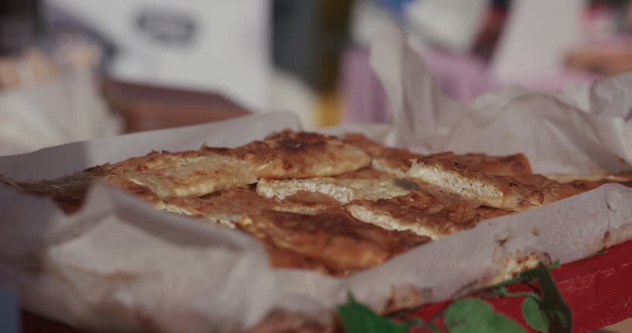 Traditional cheese pie served in a tray at Kvatric Market in Zagreb Croatia on a sunny day.