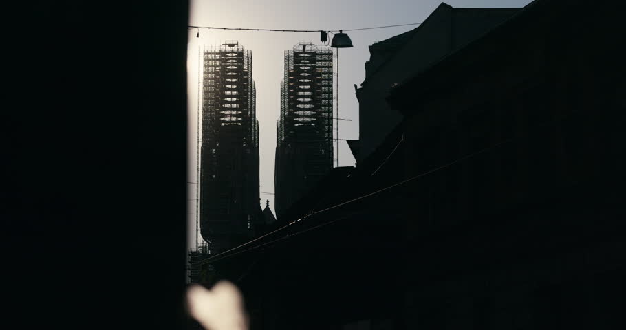 Zagreb Cathedral towers under reconstruction silhouetted against sunset light in Zagreb Croatia.