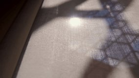 Diagonal view of sunlight passing through window with hexagonal grid, casting glowing geometric shadows across translucent curtain folds indoors - Powered by Shutterstock - Get 15% off with code: PIKWIZARD15