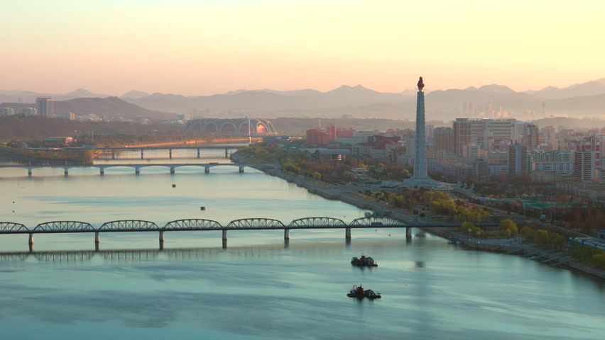 Juche Tower, Pyongyang morning panoramic view, North Korea. Taedong River in the morning fog. View facing upstream, modern residential complex. View from Yanggakdo Hotel