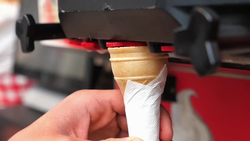 Enjoying a delicious ice cream cone creation process
