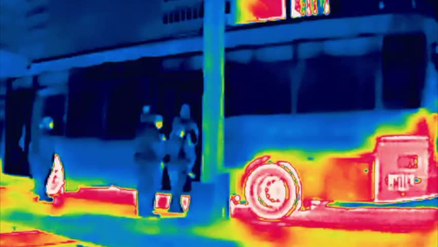City bus on the route, passenger pickup, boarding. Image from thermal imager device.