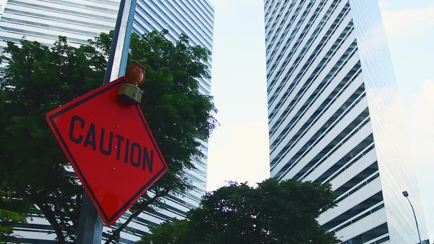 Singapore urban scene with red caution road sign near modern skyscrapers construction warning business district infrastructure. CBD.Caution banner investment and construction road works safety concept