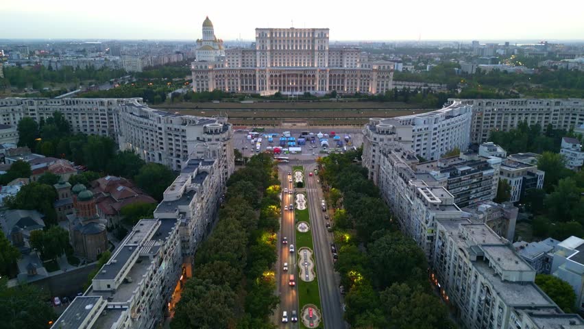 Cinematic high angle night view of the illuminated Palace of the Parliament in Bucharest, Romania.