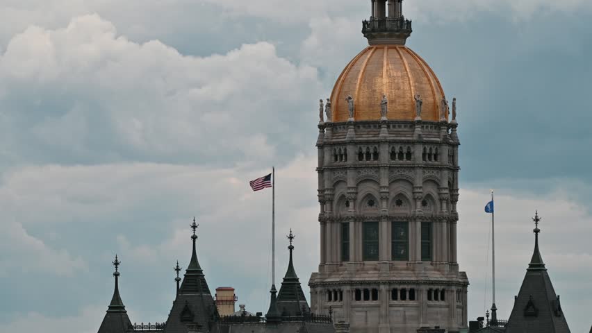 Hartford, Connecticut, USA – American Flag and Connecticut State Capitol Under Storm Clouds
