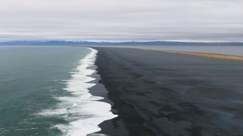Aerial view of ocean crashing on the beach. black sand. Iceland