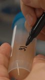 Detailed Writing Of Dates And Identifiers On Laboratory Sample Containers For Traceability . Stock clip - Powered by Shutterstock - Get 15% off with code: PIKWIZARD15