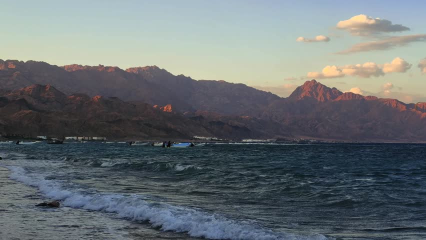 Panoramic view from the beach of seascape and Sinai Mountains on the coast at sunset