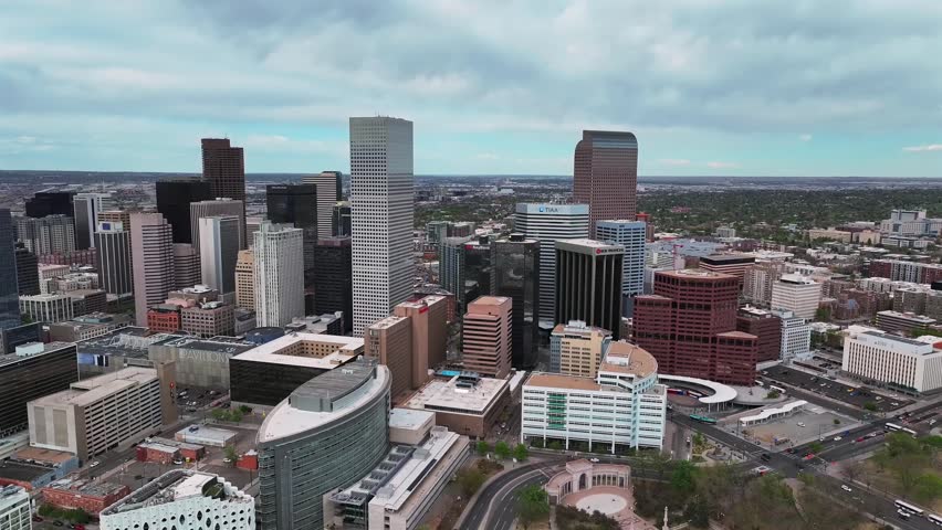 City of Denver skyscraper office buildings Lodo aerial drone Colorado Capitol Hill City Park downtown Front Range Rockies springtime cloudy afternoon cityscape landscape City Park forward down motion