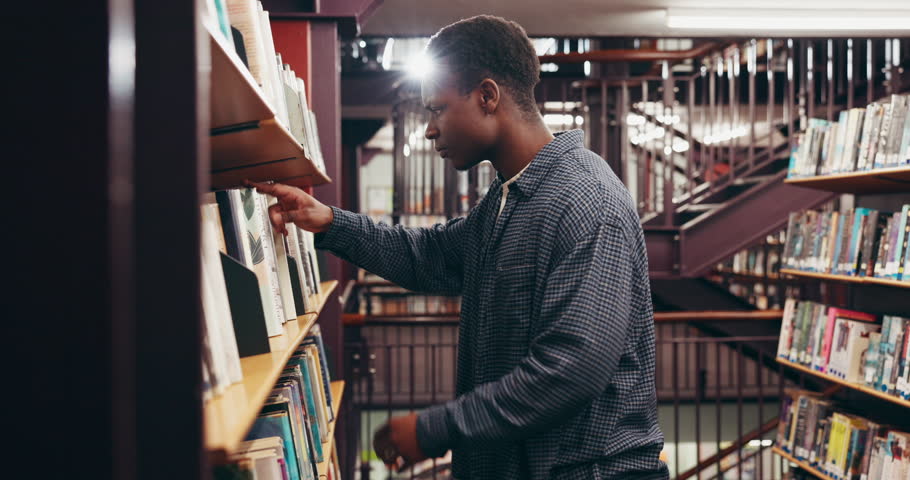 Books, university and black man in library for education, learning or research with knowledge. Studying, project and African male student with academic information for college exam on campus.