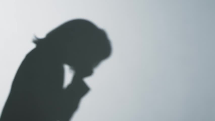 Silhouette of a woman coughing