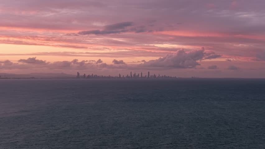 Modern Skyscrapers Of Surfers Paradise In Distance Across The Ocean During Sunset In Gold Coast, QLD. wide shot