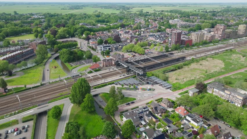 Aerial Woerden train station with train tracks close to city in urban area in Netherlands