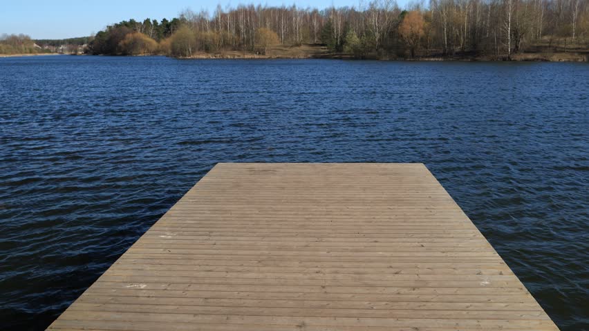 Pier, bridge on a lake, and waves on the water