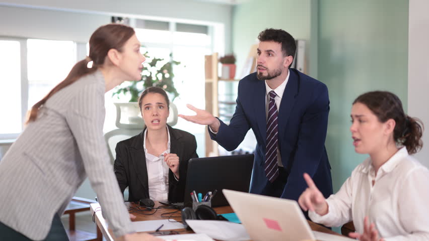 Aggressive colleagues shouting and having a loud emotional conflict while working in office