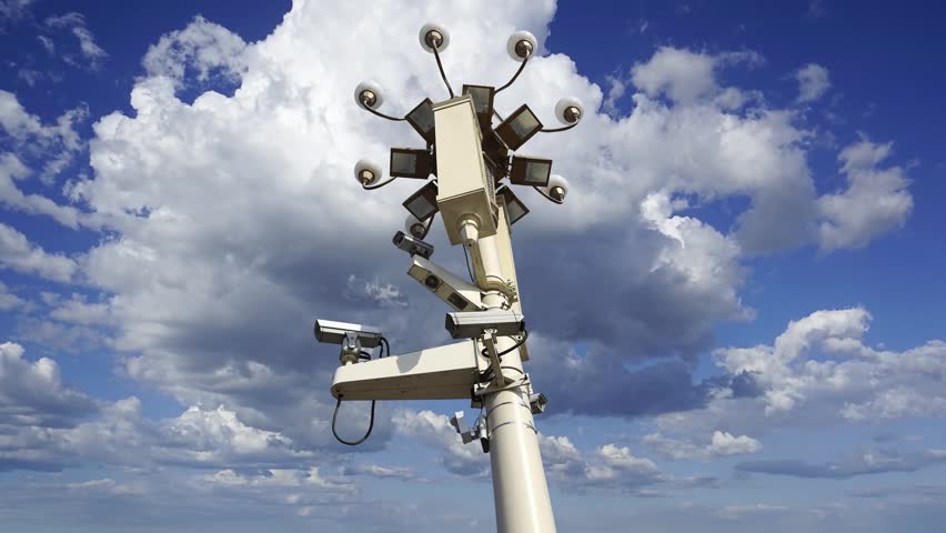 Street lamp on Tiananmen Square in Beijing, China (against the background of a beautiful sky with clouds), with propaganda or public announcement speakers. 4K, time lapse  