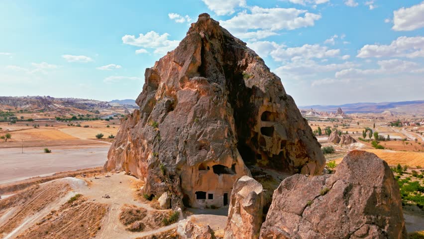 Aerial view of Cappadocia, Turkey rock hill. Rugged stone formations, dusty tracks and open countryside create a scenic landmark setting.