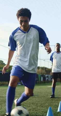 Man, running and soccer ball with cone for fitness, training and team outdoor for competition practice. Series, person and football player on field with sports drill, skill development and equipment.