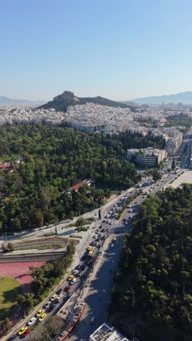Aerial view of Athens cityscape near the Acropolis and Temple of Olympian Zeus at golden hour, Greece