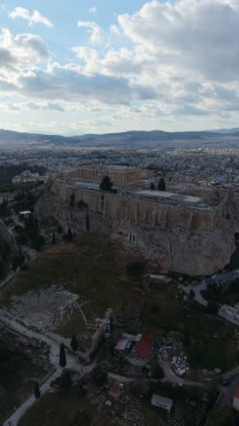 Aerial view of Athens cityscape near the Acropolis and Temple of Olympian Zeus at golden hour, Greece