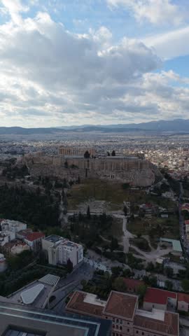 Aerial view of Athens cityscape near the Acropolis and Temple of Olympian Zeus at golden hour, Greece