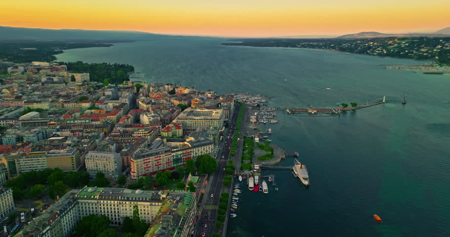 Establishing shot of Geneva city. Aerial view of the Swiss lake town. Rooftops of houses and the lake bay