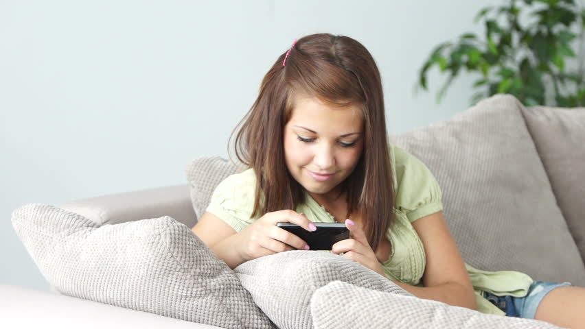Girl playing game on her phone and laughing

