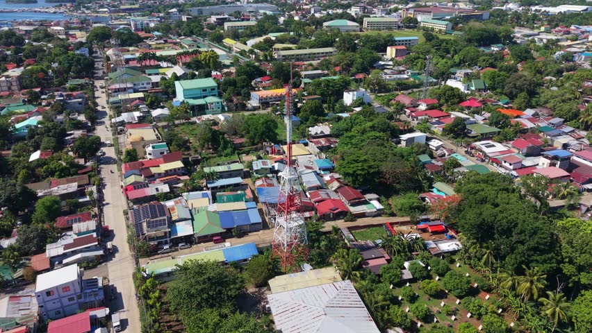 Telecommunications tower and urban infrastructure in Puerto Princesa Palawan shown above a residential city district.