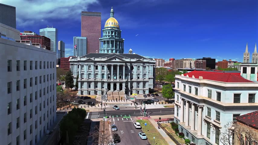 Downtown Denver tour walk sunny springtime morning blue sky Civic Center Park Colorado Capitol building aerial drone view skyscrapers tall buildings car traffic city streets Capitol Hill forward pan