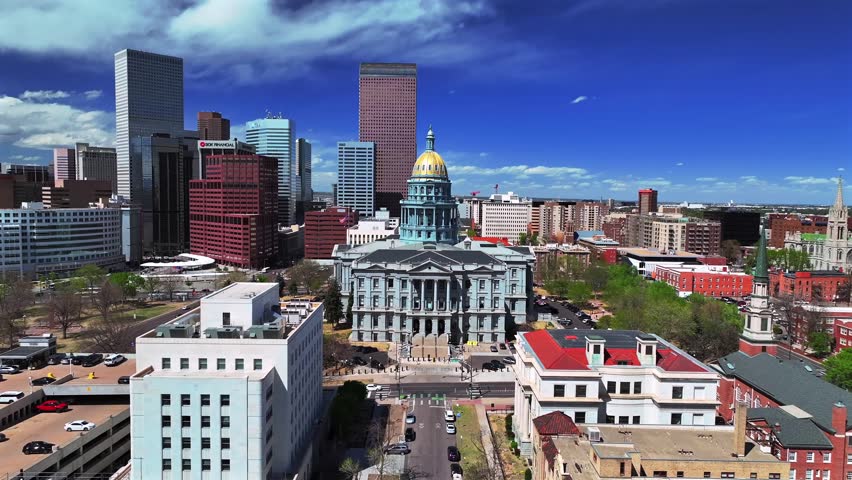 Downtown Denver sunny beautiful springtime morning blue sky Civic Center Park Colorado Capitol building aerial drone view skyscrapers tall buildings car traffic cityscape streets Capitol Hill forward