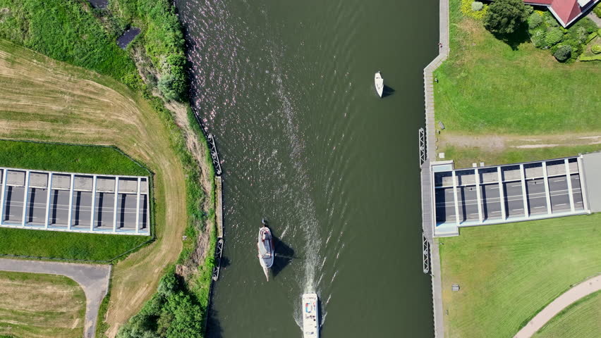 Aerial top down of sailing boats navigating near the Galamadammen aqueduct in Friesland, Netherlands, Europe.