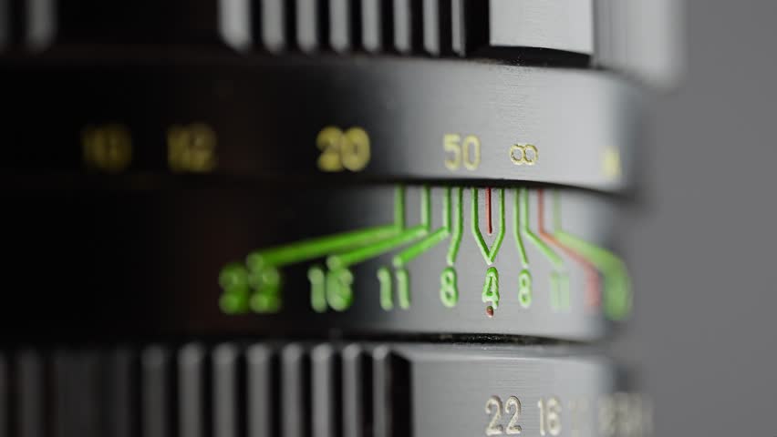 Macro of a vintage camera lens focus ring rotating