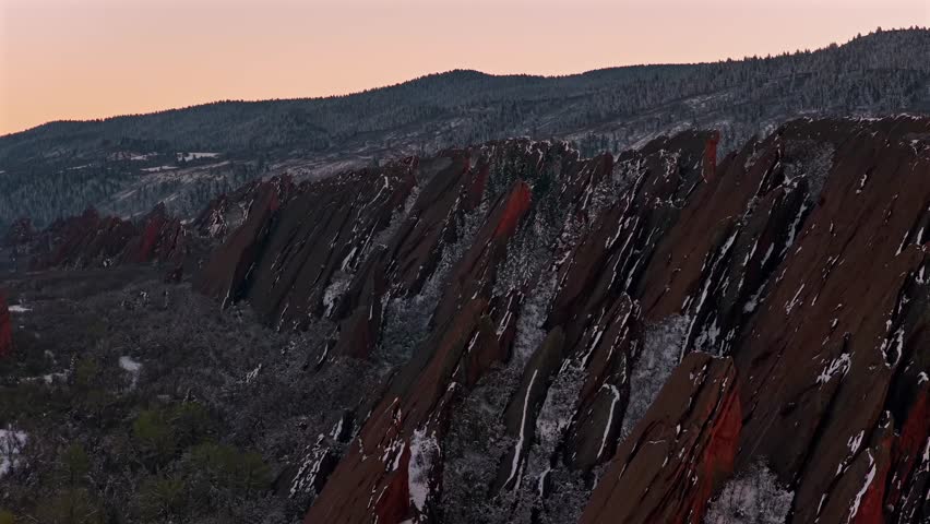 Springtime fresh snowfall Denver Front Range snow covere jagged sharp Red Rocks Peaks landmark Roxborough State Park Sterling Ranch Colorado aerial drone Fountain Valley South Rim Trail Overlook Vista